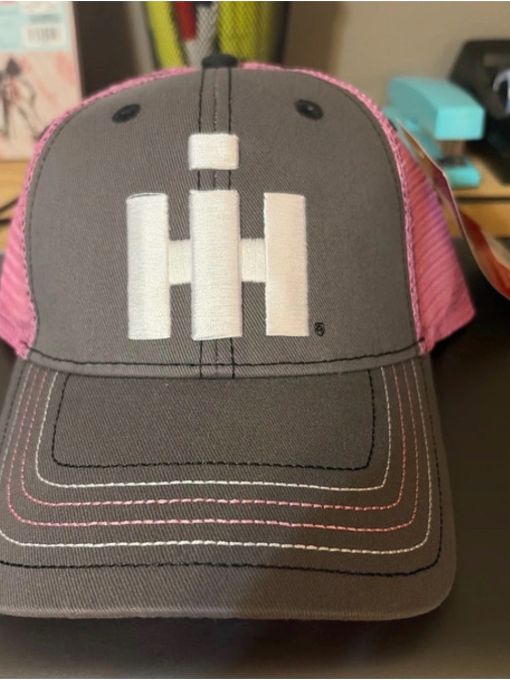 Universal Pink Mesh Trucker Hat with White IH Logo — Gray Front